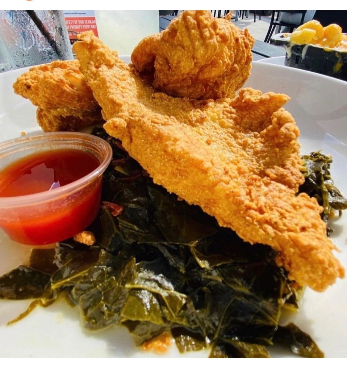 Fried fish and greens prepared by In Loving Memory Catering