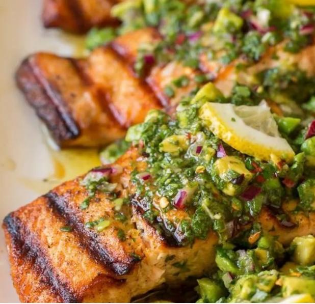 Salmon served with a fresh avocado and herb salad
